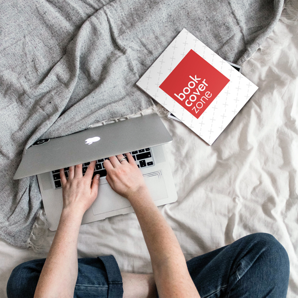 Book Mockup with Person Typing on MacBook