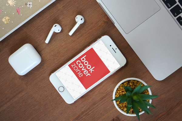 iPhone on Wood Desk with AirPods and MacBook
