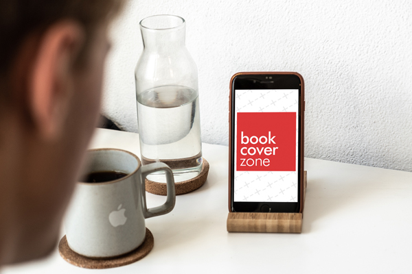 Man Looking at iPhone on Desk Dock