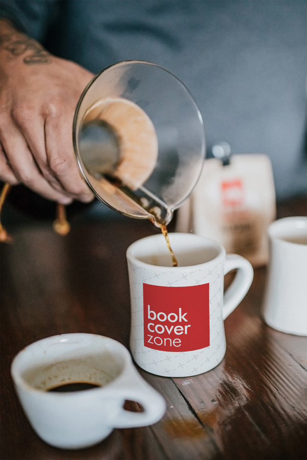 Man Pouring Coffee into Ceramic Mug
