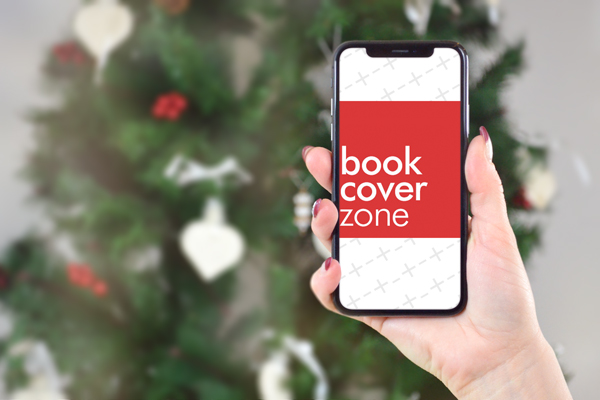Woman Holding iPhone XS on Christmas Tree Background